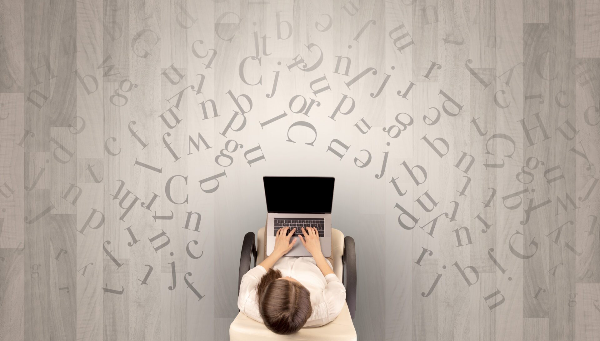 Letters with woman using laptop in a chair